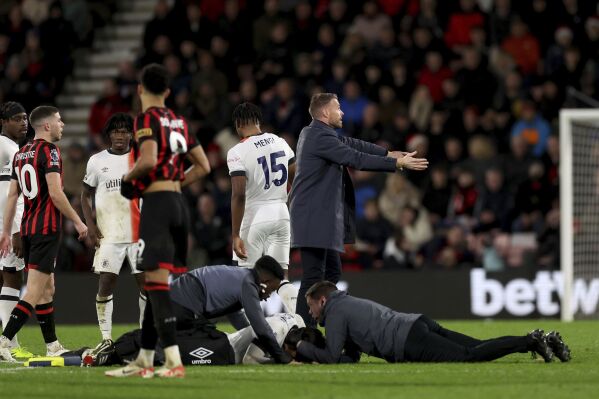 Luton Town manager Rob Edwards gestures on the pitch as his player Tom Lockyer receives treatment on the pitch during the English Premier League soccer match between Bournemouth and Luton Town at the Vitality Stadium, in Bournemouth, England, Saturday, Dec. 16, 2023. (Steven Paston/PA via AP)