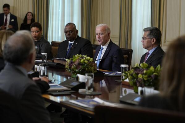 President Joe Biden, second from right, flanked by Defense Secretary Lloyd Austin, on the left, and Health and Human Services Secretary Xavier Becerra, on the right, speaks during a meeting of the White House Competition Council in the State Dining Room of the White House in Washington, Monday, Sept. 26, 2022. (AP Photo/Susan Walsh)