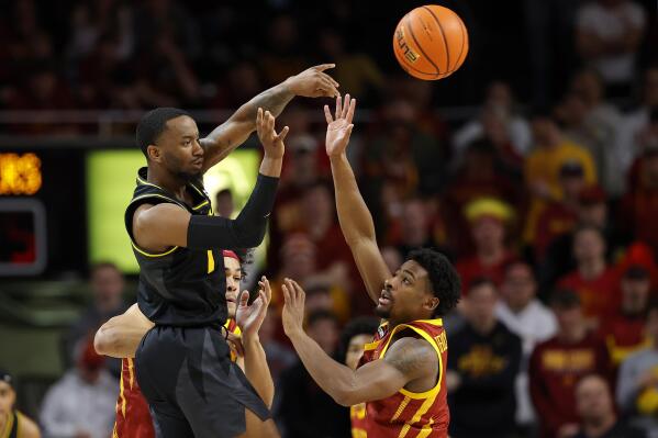 Missouri guard Amari Davis (1) passes over Iowa State guard Izaiah Brockington (1) during the first half of an NCAA college basketball game, Saturday, Jan. 29, 2022, in Ames. (AP Photo/Matthew Putney)