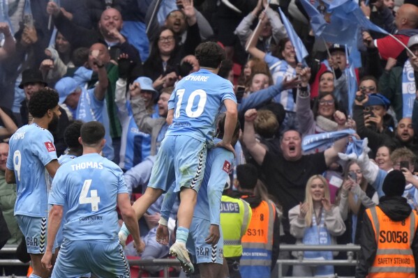 Coventry City players celebrate after scoring during the English FA Cup semifinal soccer match between Coventry City and Manchester United at Wembley stadium in London, Sunday, April 21, 2024. (AP Photo/Alastair Grant)