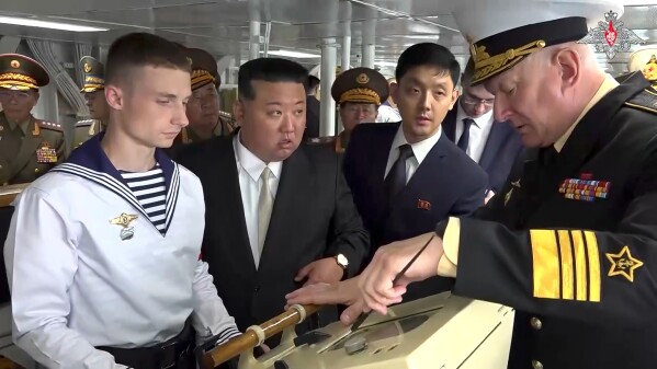 In this image taken from video released by Russian Defense Ministry Press Service on Saturday, Sept. 16, 2023, North Korea's leader Kim Jong Un, center, listens explanations by Admiral Nikolai Yevmenov, Commander-in-Chief of the Russian Navy, right, while visiting the Admiral Shaposhnikov frigate of the Russian navy in the port of Vladivostok, Russian Far East. North Korean leader Kim inspected Russia's nuclear-capable bombers and a warship in its Pacific fleet on Saturday as he continued a trip in Russia’s Far East that has sparked Western concerns about an arms alliance that could fuel Russian President Vladimir Putin’s war on Ukraine.(Russian Defense Ministry Press Service via AP)