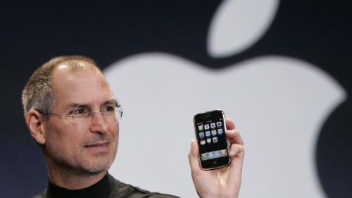 FILE - Apple CEO Steve Jobs holds up an Apple iPhone at the MacWorld Conference, Jan. 9, 2007, in San Francisco. On Sunday, July 16, 2023, a first-generation iPhone sold at auction for $190,373, almost 380 times its original price of $499 when the groundbreaking device went for sale in 2007. (AP Photo/Paul Sakuma, File)