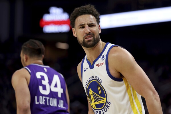 Golden State Warriors guard Klay Thompson (11) reacts after making a three-point basket against the Utah Jazz during the first half of an NBA basketball game in San Francisco, Sunday, April 14, 2024. (AP Photo/Jed Jacobsohn)