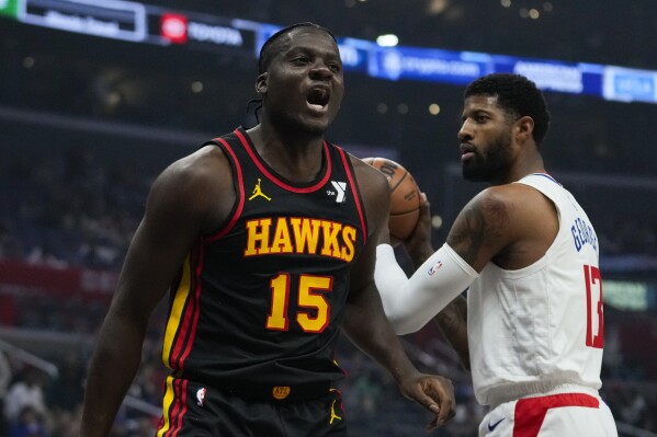 Atlanta Hawks center Clint Capela (15) celebrates after dunking during the first half of an NBA basketball game against the Los Angeles Clippers in Los Angeles, Sunday, March 17, 2024. (AP Photo/Ashley Landis)