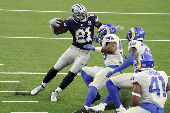 Dallas Cowboys' Ezekiel Elliott (21) runs around a group of Los Angeles Rams defenders on his way to a touchdown after a catch during the first half of an NFL football game Sunday, Sept. 13, 2020, in Inglewood, Calif. (AP Photo/Jae C. Hong )