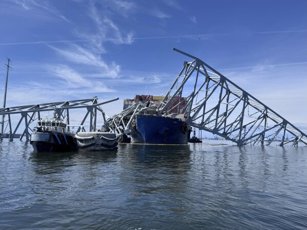 The fallen Francis Scott Key Bridge in Baltimore is pictured Sunday, March 31, 2024, where divers assisted crews with the complicated and meticulous operation of removing steel and concrete. (AP Photos/Mike Pesoli)