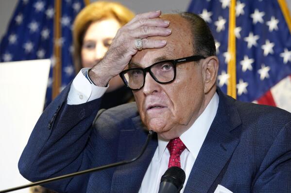 FILE - In this Nov. 19, 2020, file photo, former New York Mayor Rudy Giuliani, who was a lawyer for President Donald Trump, speaks during a news conference at the Republican National Committee headquarters in Washington.  The House committee investigating the Capitol insurrection has issued subpoenas to some of Donald Trump's closest advisers, including Rudy Giuliani  Sidney Powell stands behind. (AP Photo/Jacquelyn Martin, File)