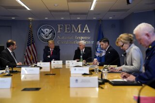 FILE - In this March 19, 2020, file photo, President Donald Trump attends a teleconference with governors at the Federal Emergency Management Agency headquarters, Thursday, March 19, 2020, in Washington. From left, Department of Health and Human Services Secretary Alex Azar, Trump, Vice President Mike Pence, Acting Secretary of Homeland Security Chad Wolf, White House coronavirus response coordinator Dr. Deborah Birx and Adm. Brett Giroir, assistant secretary for health. There’s the standard process for getting urgently needed coronavirus equipment: send a request to FEMA. Then there’s the other way: have a buddy who can pick up the phone and call the Trump White House. Trump’s team has proudly recounted instances where a call to the White House has produced fast results for those who have an in with the president.  (AP Photo/Evan Vucci, Poolm, File)