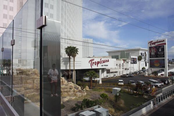 A person, reflected in glass, walks near the Tropicana Las Vegas, Tuesday, May 16, 2023, in Las Vegas. Nevada Gov. Joe Lombardo announced Wednesday, May 24, 2023, a tentative agreement between his office, legislative leaders in the state and the Oakland Athletics for a baseball stadium funding plan after weeks of negotiations over how much public assistance the state will contribute to a $1.5 billion ballpark in Las Vegas, according to a joint statement. The bill comes on the heels of the Athletics’ purchase of land on the southern end of the Las Vegas Strip where the Tropicana Las Vegas casino resort sits. (AP Photo/John Locher)