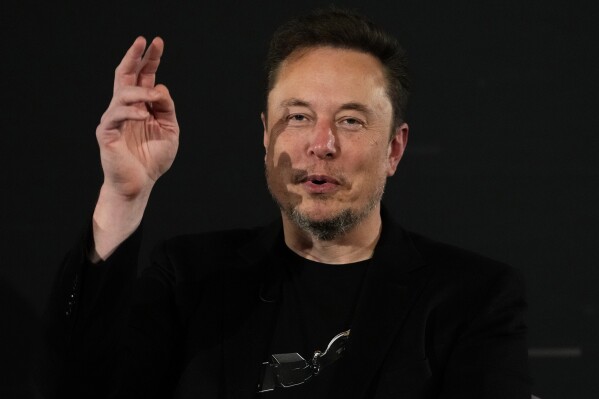 File - Elon Musk, owner of social media platform X, gestures during an event with Britain's Prime Minister Rishi Sunak in London on Nov. 2, 2023. IBM has stopped advertising on X after a report said its ads were appearing alongside material praising Adolf Hitler and Nazis. (AP Photo/Kirsty Wigglesworth, Pool, File)