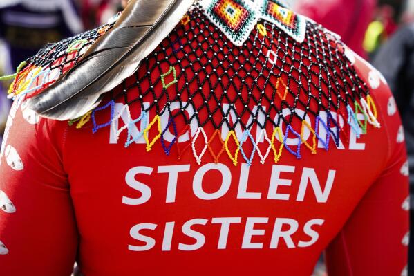 A marcher wears a shirt reading "No more stolen sisters" during the third annual march and gathering for Missing & Murdered Indigenous Women, People & Families, hosted by the grassroots organization MMIWP Families, Saturday, May 6, 2023, in Seattle. (AP Photo/Lindsey Wasson)