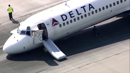 A Delta plane lands without its landing gear at the Charlotte Douglas International Airport, Wednesday, June 28, 2023 in Charlotte, N.C. The airport said in a tweet that the runway was closed following a mechanical issue with Delta Air Lines. No injuries were reported and all passengers were taken to the terminal. The airport said it was working to remove the aircraft and reopen the runway. (WSOC-TV via AP)