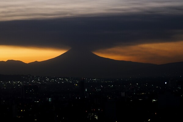 The Popocatepetl volcano emits smoke and ash, seen from Mexico City at sunrise on Tuesday, Feb. 27, 2024. The volcano known as 