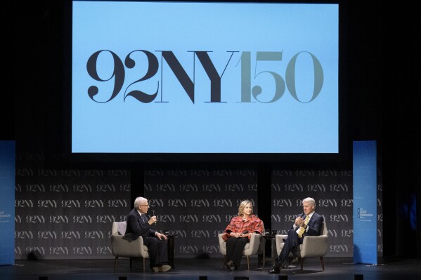FILE - Former President Bill Clinton, right, and former Secretary of State Hillary Rodham Clinton, center, speak with David Rubenstein at the 92nd Street Y on May 4, 2023, in New York. Oprah Winfrey, Rachel Maddow and Arnold Schwarzenegger will be among those appearing this fall at the 92nd Street Y, a New York City cultural institution and community center marking its 150th anniversary. (Photo by Evan Agostini/Invision/AP, File)