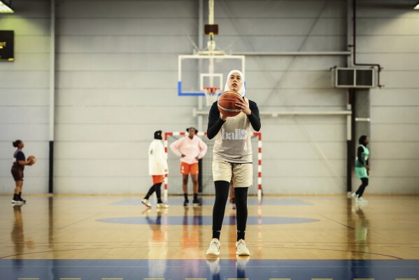 A player wearing a headscarf warms-up before a basketball game, in Aubervilliers near Paris, Sunday, April 27, 2025. (AP Photo/Thomas Padilla)