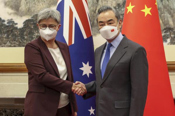 Australian Foreign Minister Penny Wong shakes hands with Chinese Foreign Minister Wang Yi in Beijing, Wednesday, Dec. 21, 2022. Australia's foreign minister is in China for talks seeking to mend a long break in high-level ties that have prompted trade sanctions and political frictions. (Sarah Friend/DFATvia AP)