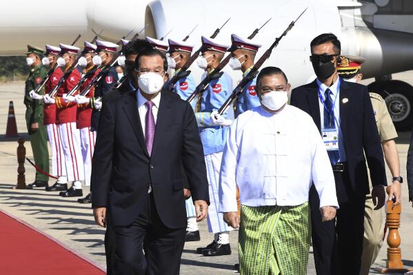 FILE. - In this photo provided by An Khoun Sam Aun/National Television of Cambodia, Cambodian Prime Minister Hun Sen, left, reviews an honor guard with Myanmar Foreign Minister Wunna Maung Lwin, front right, on his arrival at Naypyitaw International Airport in Naypyitaw, Myanmar, on Jan 7, 2022. Cambodia, the current ASEAN chair, said earlier February, 2022, that members of the regional group had failed to reach a consensus on inviting Myanmar Foreign Minister Wunna Maung Lwin to its meetings this week, in Cambodia's capital, Phnom Penh.(An Khoun Sam Aun/National Television of Cambodia via AP, File)