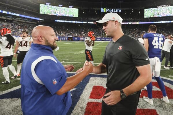 Cincinnati Bengals head coach Zac Taylor, right, shakes hands with New York Giants head coach Brian Daboll after an NFL football game Sunday, Aug. 21, 2022, in East Rutherford, N.J. The Giants won 25-22. (AP Photo/John Munson)