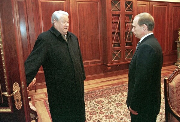 FILE - Former President Boris Yeltsin, left, smiles as he talks to the then Russian acting President and Premier Vladimir Putin, at the Kremlin, Russia, on Dec. 31, 1999. In a surprise address to the nation, President Boris Yeltsin announces his resignation and makes Putin, the prime minister he appointed four months earlier, the acting president. (Sputnik, Kremlin Pool Photo via AP, File)