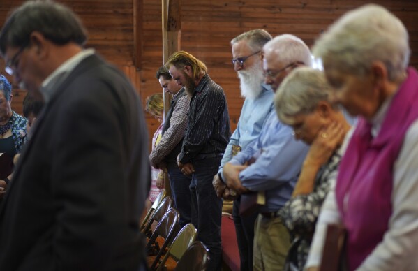 Sacred Harp singers pray at the end of a session at Holly Springs Primitive Baptist Church in Bremen, Ga., on Sunday, March 23, 2025. (AP Photo/Jessie Wardarski)