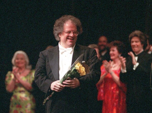 FILE - James Levine, center, the artistic director of the Metropolitan Opera, appears at a curtain call for the gala celebrating his 25th anniversary with the company in New York on April 28, 1996. Levine, who ruled over the Metropolitan Opera for 4 1/2 decades before being eased out when his health declined and then fired for sexual improprieties, died March 9, 2021 in Palm Springs, Calif., of natural causes, his physician of 17 years, Dr. Len Horovitz, said Wednesday, March 17. He was 77. (AP Photo/Osamu Honda, File)