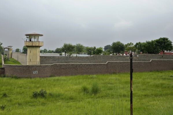 Police officers stand guard on the watch towers of district prison Attock, where Pakistan's former Prime Minister Imran Khan in-prison after his conviction, in Attock, Pakistan, Sunday, Aug. 6, 2023. Khan was arrested Saturday after a court handed him a three-year jail sentence for corruption, a development that could end his future in politics. (AP Photo/Anjum Naveed)