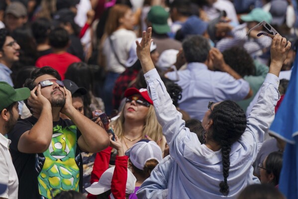 People watch a total solar eclipse in Mazatlan, Mexico, Monday, April 8, 2024. (AP Photo/Fernando Llano)