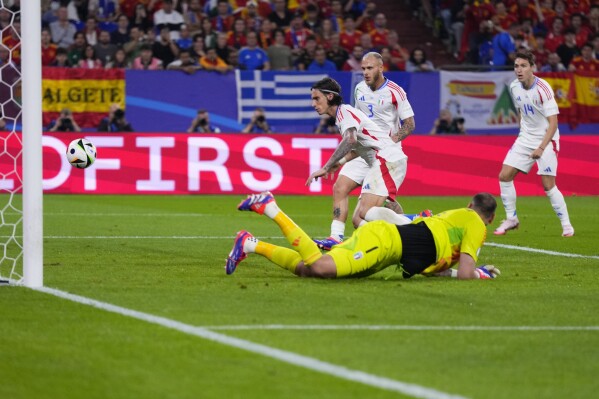 Italy's Riccardo Calafiori (5) scores an own goal during a Group B match between Spain and Italy at the Euro 2024 soccer tournament in Gelsenkirchen, Germany, Thursday, June 20, 2024. (AP Photo/Manu Fernandez)