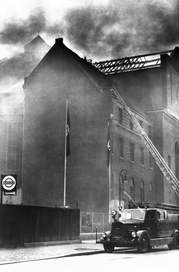 FILE - A fire truck with an extended ladder is parked on Prinzregenten Street in Berlin next to a synagogue that was set on fire on Nov. 10, 1938, during the organized Kristallnacht rampage carried out by Nazi paramilitary forces and German civilians over two days. During the violence perpetrators set fire to hundreds of synagogues, looted thousands of Jewish businesses and attacked Jews throughout Germany. (AP Photo, File)