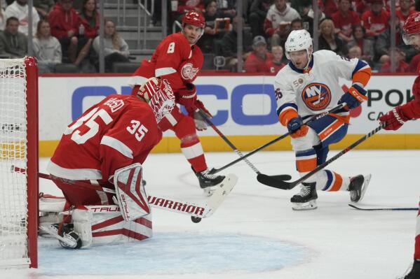 Detroit Red Wings goaltender Ville Husso (35) stops a New York Islanders right wing Oliver Wahlstrom (26) shot in the first period of an NHL hockey game Saturday, Nov. 5, 2022, in Detroit. (AP Photo/Paul Sancya)