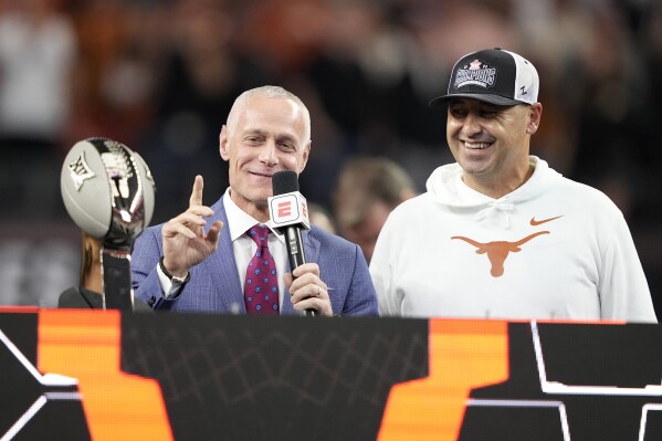 Big 12 Commissioner Brett Yormark, left, stands by Texas head coach Steve Sarkisian, right, as he makes comments after the Big 12 Conference championship NCAA college football game against Oklahoma State in Arlington, Texas, Saturday, Dec. 2, 2023. (AP Photo/Tony Gutierrez)