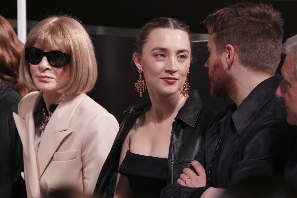 Anna Wintour, from left, Saoirse Ronan and husband Jack Lowden, are photographed ahead of the Louis Vuitton Fall/Winter 2025-2026 Womenswear collection presented in Paris, Monday, March 10, 2025. (Photo by Scott A Garfitt/Invision/AP)