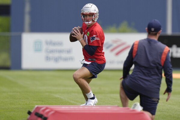 New England Patriots quarterback Drake Maye performs drills during an NFL football practice, Monday, May 20, 2024, in Foxborough, Mass. (AP Photo/Steven Senne)