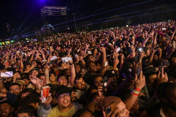 FILE - The crowd watches as Travis Scott performs at Astroworld Festival at NRG park on Friday, Nov. 5, 2021 in Houston. Nearly two years after 10 people were crushed to death during the deadly 2021 Astroworld festival, no charges have been filed despite at least some people, including workers, expressing safety concerns about the event.(Jamaal Ellis/Houston Chronicle via AP, File)