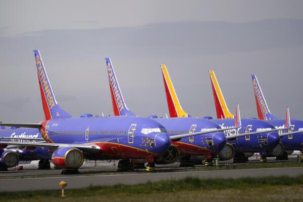 A line of Southwest Air Boeing 737 jets are parked near the company's production plant while being stored at Paine Field Friday, April 23, 2021, in Everett, Wash. Boeing reported its first quarterly profit since 2019 and revenue topped expectations, as the giant aircraft maker tries to dig out from the most difficult stretch in its history. Boeing said Wednesday, July 28, 2021, that it earned $567 million in the second quarter, compared with a $2.4 billion loss a year ago. (AP Photo/Elaine Thompson)