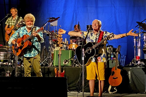 FILE - In this Thursday, Feb. 9, 2023, photo provided by the Florida Keys News Bureau, singer-songwriter Jimmy Buffett, right, along with members of his Coral Reefer Band including Mac McAnally, center, perform during a concert in Key West, Fla. Buffett, who popularized beach bum soft rock with the escapist Caribbean-flavored song “Margaritaville” and turned that celebration of loafing into an empire of restaurants, resorts and frozen concoctions, has died, Friday, Sept. 1, 2023. (Howard Livingston/Florida Keys News Bureau via AP)