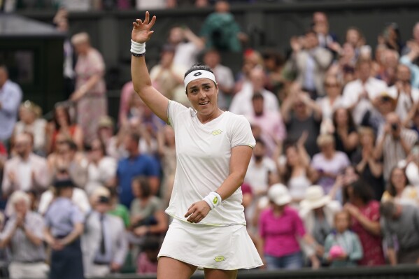 Tunisia's Ons Jabeur celebrates beating Aryna Sabalenka of Belarus to win their women's singles semifinal match on day eleven of the Wimbledon tennis championships in London, Thursday, July 13, 2023. (AP Photo/Alberto Pezzali)
