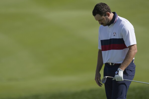 United States' Patrick Cantlay react after chipping onto the 16th green during his morning Foursomes match at the Ryder Cup golf tournament at the Marco Simone Golf Club in Guidonia Montecelio, Italy, Saturday, Sept. 30, 2023. (AP Photo/Andrew Medichini)