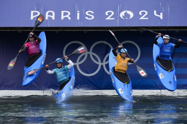 Monica Doria Vilarrubla of Andorra, from left, competes in the women's kayak cross race against Eliska Mintalova of Slovakia, Haruka Okazaki of Japan and Li Shiting of China at the 2024 Summer Olympics, Saturday, Aug. 3, 2024, in Vaires-sur-Marne, France. (AP Photo/Kirsty Wigglesworth)