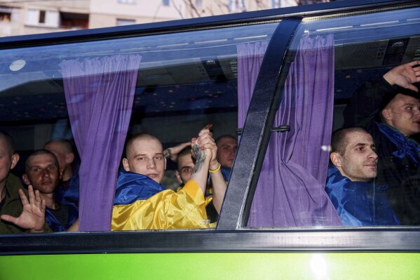 Ukrainian servicemen ride in a bus after returning from captivity in a POW exchange in Ukraine, on Saturday, April. 19, 2025. (AP Photo/Evgeniy Maloletka)