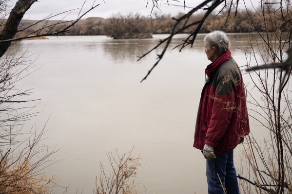 Gayna Salinas looks out over the Green River, a tributary of the Colorado River, Thursday, Jan. 25, 2024, in Green River, Utah. (AP Photo/Brittany Peterson)