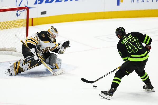 Dallas Stars forward Alexander Radulov (47) fakes out Boston Bruins goaltender Linus Ullmark (35) while skating in to score on a breakaway during the first period of an NHL hockey game, Sunday, Jan. 30, 2022, in Dallas. Radulov would score on the play. (AP Photo/Brandon Wade)