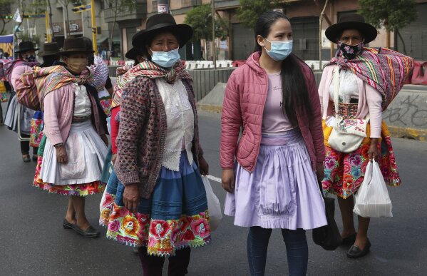 Andean protesters, wearing protective face masks amid the new coronavirus pandemic, gather outside the Congress building demanding the government attend to their health needs, in Lima, Peru, Tuesday, Dec. 1, 2020. (AP Photo/Martin Mejia)