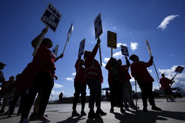FILE - United Auto Workers members walk the picket line at the Ford Michigan Assembly Plant in Wayne, Mich., Monday, Sept. 18, 2023. (AP Photo/Paul Sancya, File)