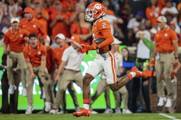 FILE - Clemson cornerback Nate Wiggins (2) returns an interception for a touchdown against Florida Atlantic in an NCAA college football game Sept. 16, 2023, in Clemson, S.C. The Baltimore Ravens selected Wiggins in the NFL draft Thursday, April 25, 2024. (AP Photo/Jacob Kupferman, File)