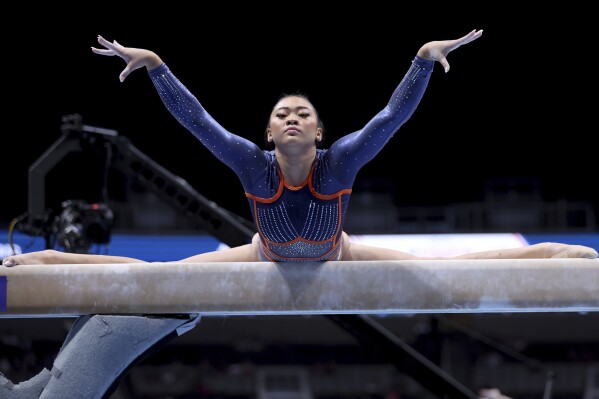 FILE - Suni Lee competes on the balance beam at the U.S. Gymnastics Championships, Friday, Aug. 25, 2023, in San Jose, Calif. Olympic gymnastics all-around champion Suni Lee revealed this week that at the height of a mystery kidney ailment last year, she gained around 45 pounds in water weight that made her question whether a return to top form was even possible. (AP Photo/Jed Jacobsohn, File)