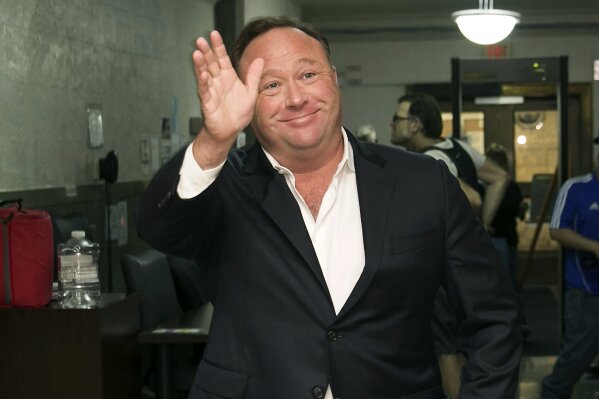 
              FILE - In this April 19, 2017, file photo, Alex Jones, a right-wing radio host and conspiracy theorist, arrives at the courthouse in Austin, Texas. A judge has denied conspiracy theorist Jones' request Wednesday, Aug. 29, 2018, to dismiss a lawsuit surrounding the 2012 Sandy Hook Elementary School massacre that he has called a hoax. The Infowars host is being sued for defamation in Texas by the parents of a 6-year-old who was among the 20 children and six adults killed in the Newtown, Conn., attack. (Jay Janner/Austin American-Statesman via AP, File)
            
