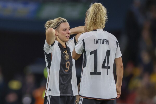 Germany's Svenja Huth, left, and Lena Lattwein react following the Women's World Cup Group H soccer match between South Korea and Germany in Brisbane, Australia, Thursday, Aug. 3, 2023. (AP Photo/Aisha Schulz)