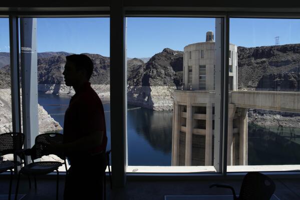 People attend a news conference on Lake Mead at Hoover Dam, Tuesday, April 11, 2023, near Boulder City, Nev. The Biden administration on Tuesday released an environmental analysis of competing plans for how Western states and tribes reliant on the dwindling Colorado River should cut their use. (AP Photo/John Locher)