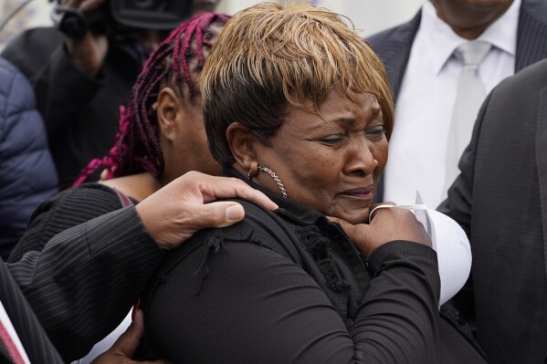 FILE - Bettersten Wade, mother of Dexter Wade, who died after being hit by a Jackson, Miss., police SUV driven by an off-duty officer, cries after her son's body is exhumed from a pauper's cemetery in Raymond, Miss., Nov. 13, 2023. A judge on Friday, May 31, 2024, ordered the enforcement of a lawsuit settlement between the city of Jackson and the family of 62-year-old George Robinson, who died after police officers pulled him from a car while searching for a murder suspect in 2019. Wade is Robinson's sister and one of the plaintiffs in the lawsuit against the city. (AP Photo/Rogelio V. Solis, File)